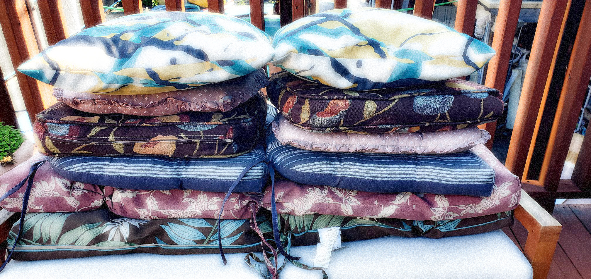Stack of cushions of various colors and patterns
